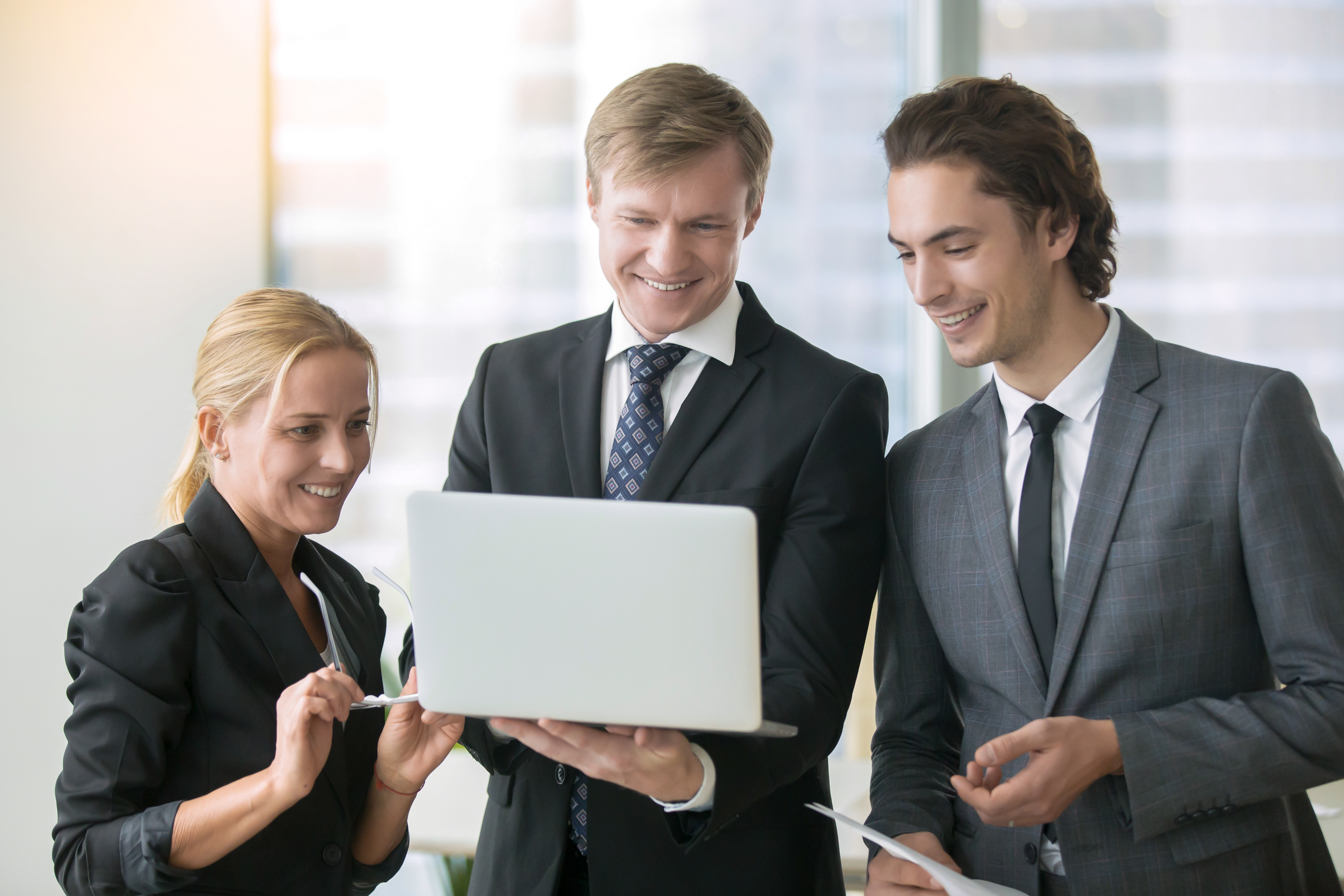 Business team reviewing results on a laptop