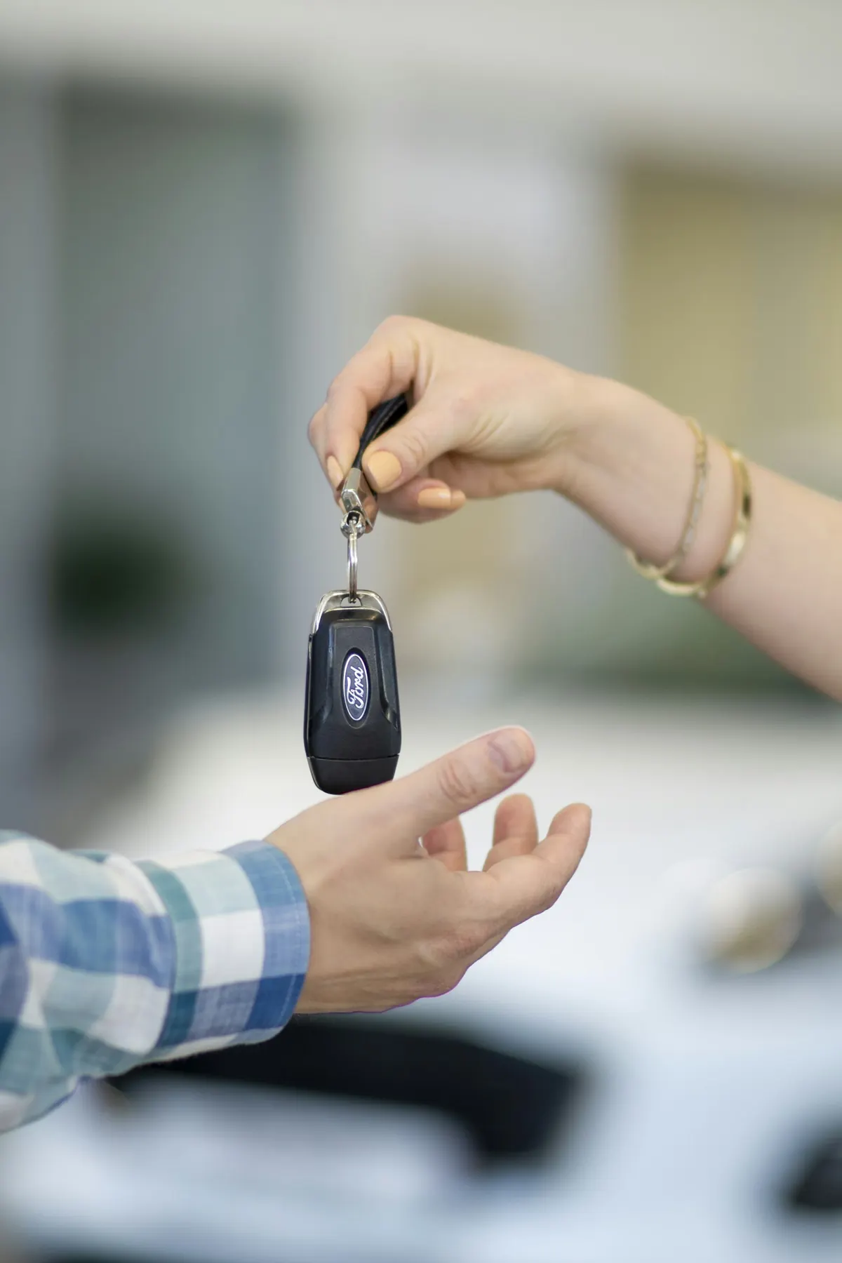 Customer receiving car keys from a salesperson