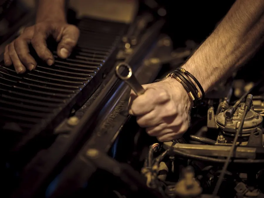 Mechanic's hands working on an engine with a wrench