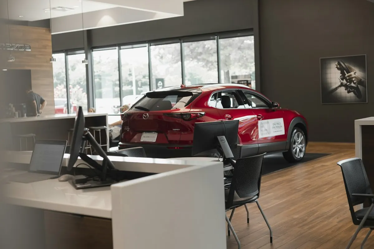 Red car on display in a dealership showroom