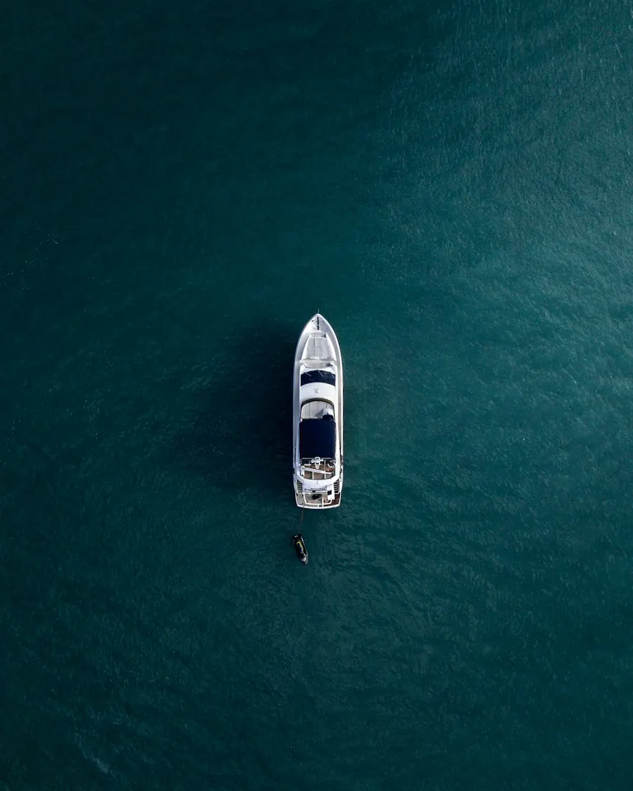 Aerial view of a yacht on teal water