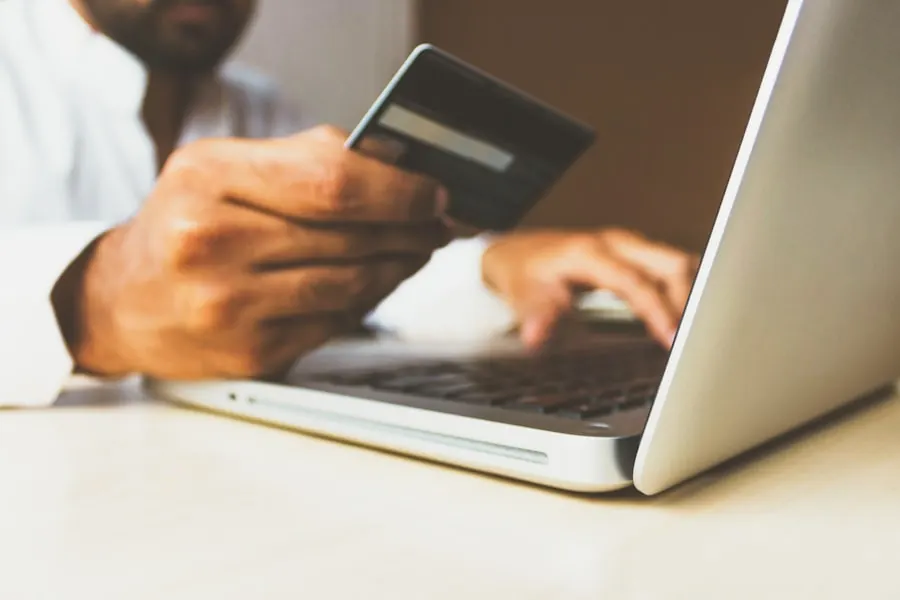 Buyer placing an order on a laptop with a company card