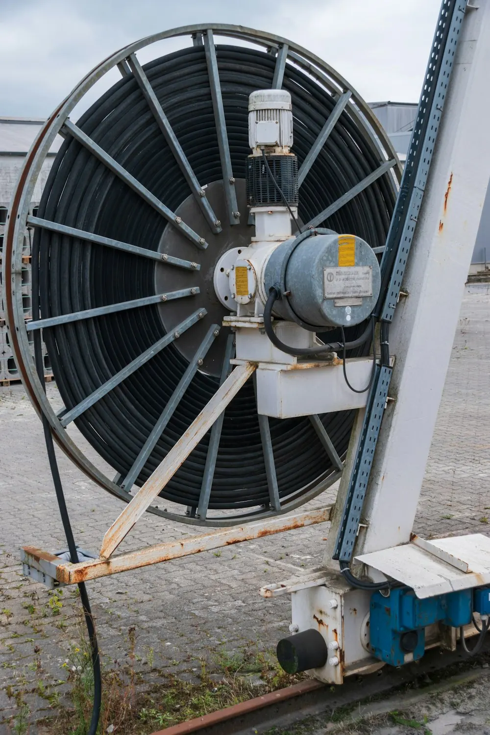 Large industrial reel of black coiled cable