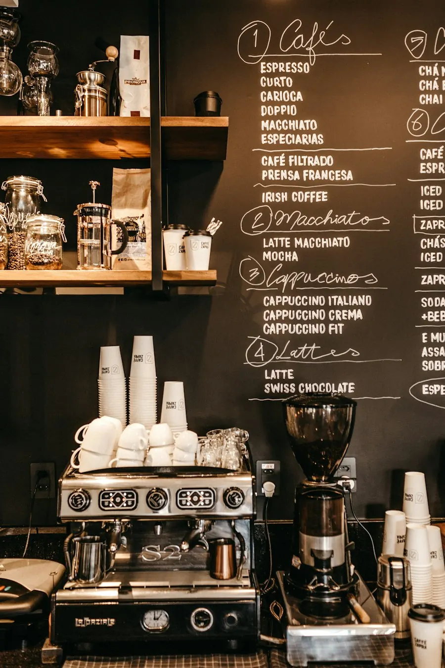 Espresso machine below a chalkboard menu in a cafe