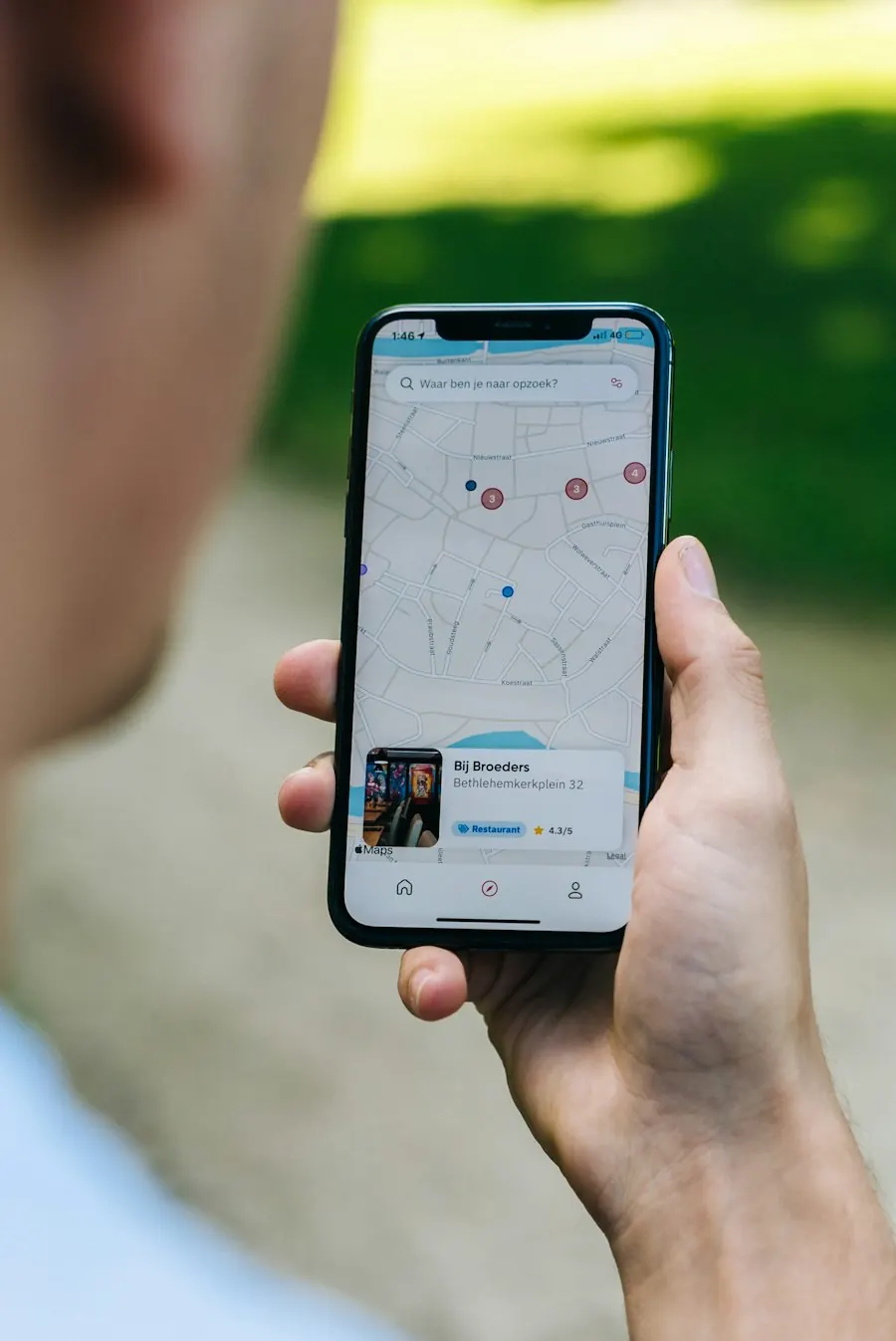 Person holding a smartphone to search nearby