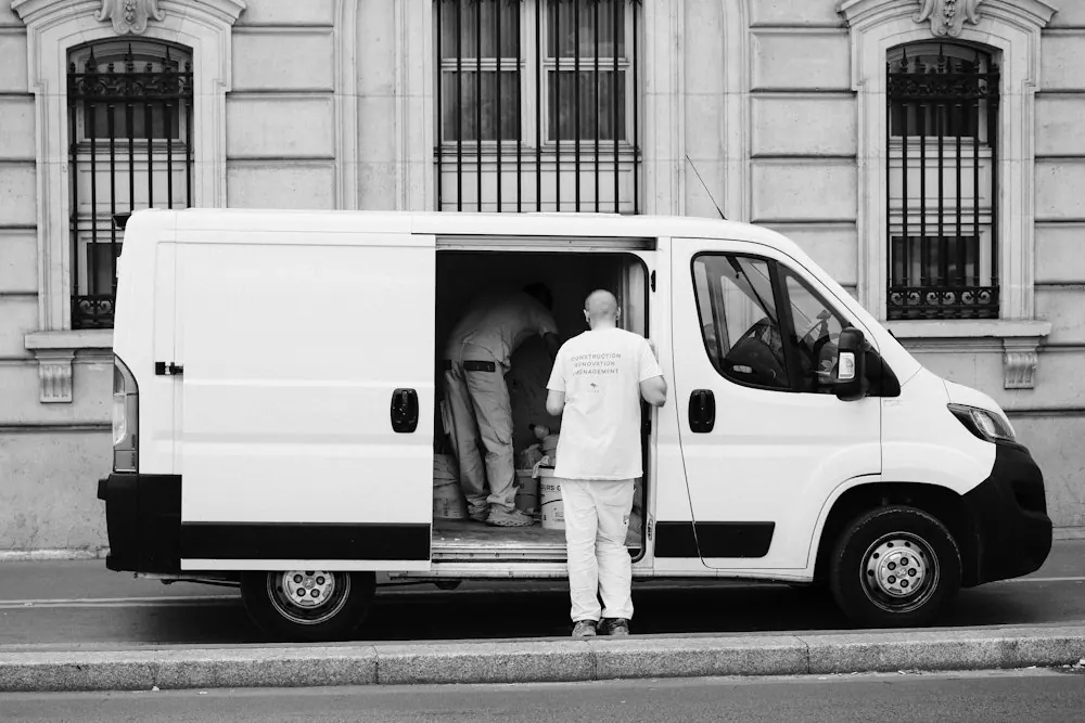 Service technician standing next to a work van