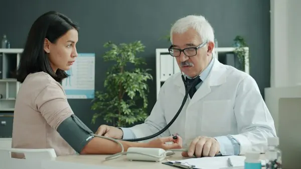 Doctor checking an elderly patient