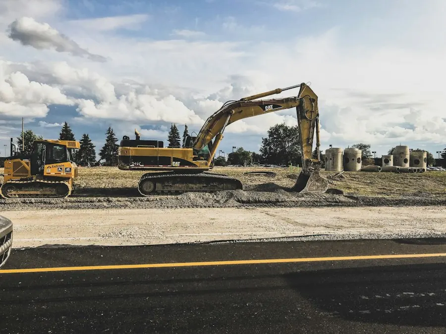 Yellow excavator digging up dirt