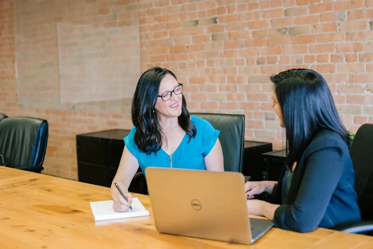 Attorney in a suit meeting with a client at a table