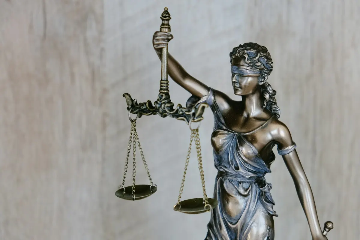 Statue of Lady Justice holding a sword against the sky