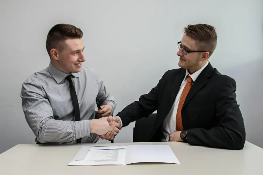 Two men shaking hands and smiling