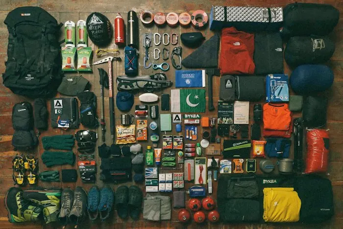 Hiking and camping gear laid out flat