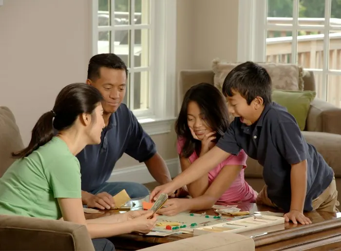Family playing a board game together