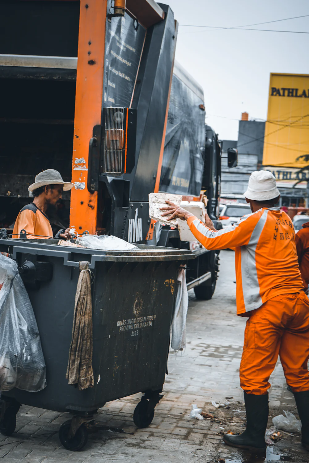 Crew at the back of a garbage truck