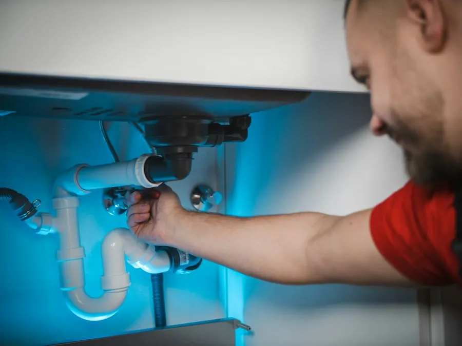Technician installing equipment under a sink